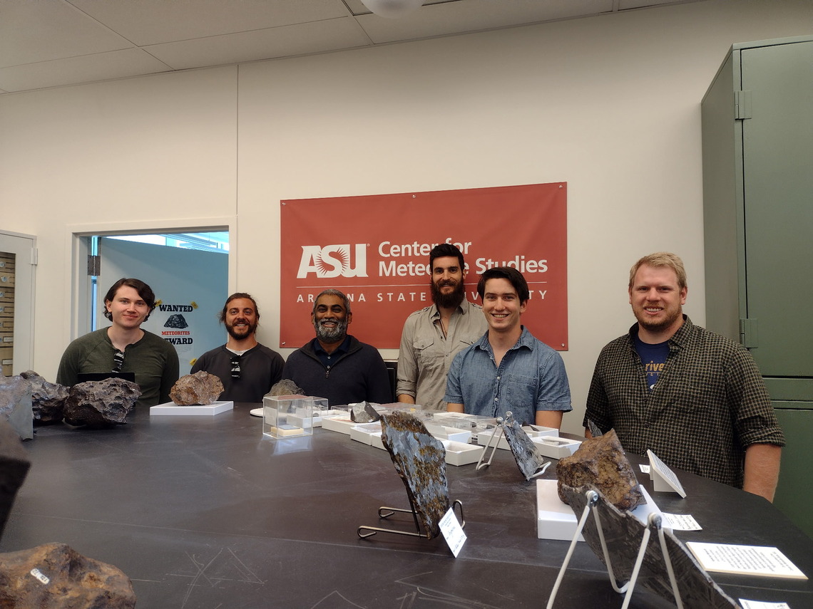 Group of students and professors standing in museum